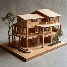 a wooden model of a house with balconies and trees