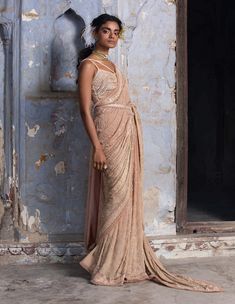 Editor's Note This stunning set features a beige ombre georgette sari, comes with a net blouse intricately embroidered with delicate beadwork, sequins, and sparkling crystals, adding a touch of glamour to the overall look. The combination of the elegant drape and the intricate embroidery creates a perfect balance of traditional and modern style, making it a perfect choice for any formal occasion. Color: Beige Fabric: Sari: georgette, blouse: organza, petticoat: shantoon Components: Sari, blouse, Beige Saree, Saree Georgette, Net Blouse, Sequin Saree, Tassel Belt, Net Blouses, Elegant Drapes, Cocktail Reception, Georgette Saree