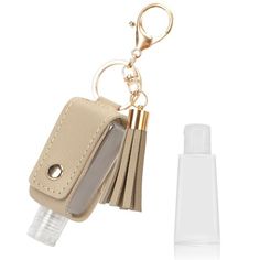 a keychain with a bottle in it and an empty plastic container next to it