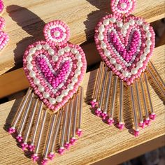 Lovely In Shape, And Finely Detailed In Beadwork, These Earrings Are A Sure Standout. Hues Of Pink, Magenta And White Are Accented By Silver. A Wonderful, Sparkling Harmony Of Colors And Form! Glass , Acrylic , Cotton Fabric & Iron Metal Adjustable Beaded Earrings With Heart And Round Beads, Beaded Dangle Heart Earrings For Parties, Pink Beaded Heart Earrings For Valentine's Day, Bohemian Pink Earrings With Heart Beads, Bohemian Heart Shaped Beaded Earrings, Bohemian Heart-shaped Beaded Earrings, Pink Heart-shaped Beaded Earrings, Dangle Beaded Earrings With Heart Beads For Party, Pink Beaded Heart Earrings For Party