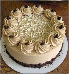 a cake with white frosting and chocolate decorations