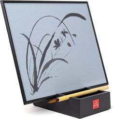 a black box with a pen in it and a drawing on the inside of it