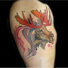 a tattoo with an image of a moose's head and antlers on it