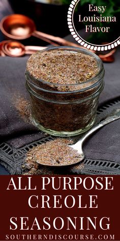 an image of all purpose creole seasoning in a glass jar with spoons on the side