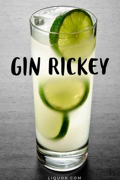 a tall glass filled with ice and limes on top of a wooden table next to the words gin rickey