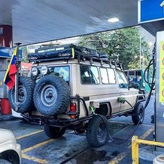 an off road vehicle at a gas station