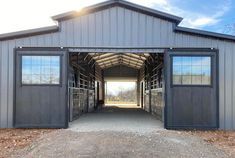 the inside of a barn with doors open