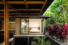 the bedroom is surrounded by plants and trees