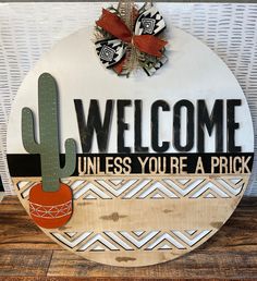 a welcome sign with a cactus on it and the words unless you're a pick