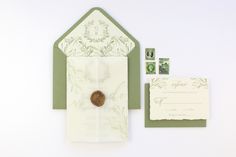 an envelope with a wax stamp on it and some other items to be used for the wedding