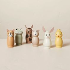 five small ceramic animals lined up in a row