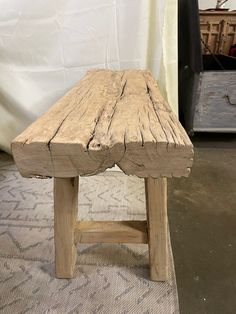 a wooden bench sitting on top of a rug