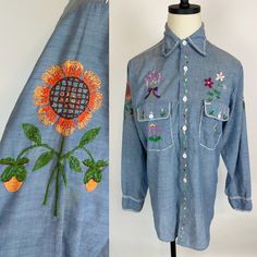 Groovy 1970s hand embroidered BIG MAC denim chambray hippie shirt. Lightweight, super soft cotton blend. Button front. Men's workshirt altered for a womens fit.  SIZE: Modern Women's Small CONDITION: Very good! Light general wear. Some distressing to chain stitch embroidery at shoulder. Bust: 39" Waist: 36" Hips: 38"  Length: 30" Shoulder to shoulder: 16" across Sleeve length: 23" Bohemian Cotton Button-up Shirt, Bohemian Embroidered Button-up Shirt, Bohemian Embroidered Button-up Tops, Bohemian Embroidered Shirt For Spring, Bohemian Embroidered Spring Shirt, Embroidered Denim Shirt For Summer, Summer Embroidered Denim Shirt, Bohemian Shirt With Floral Embroidery For Fall, Bohemian Fitted Embroidered Shirt