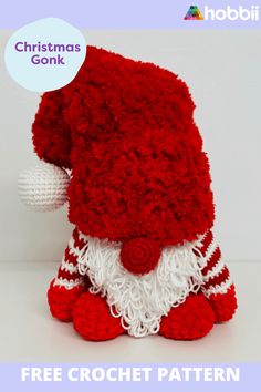 a red and white knitted santa claus hat on top of a small stuffed animal