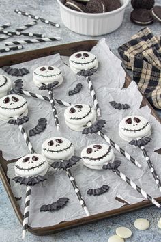 there are many cupcakes decorated like jack skewers on the tray with candy sticks