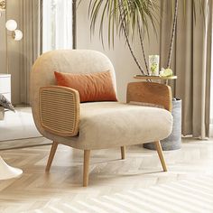 a living room with a chair, table and potted plant