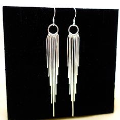 Shinny tassel earrings made by 925 sterling silver , with 11 strings of tassels each, they are just Absolutely Stunning. Perfect for everyday and special occasions . One of my Customers said they are like " flowing silver river"  . For Matching Necklace please go: https://www.etsy.com/listing/1453303841/tassel-necklace-sterling-silver-long?click_key=411a8703bb3458c8fddd241b95e632a9e5ec40cd%3A1453303841&click_sum=4f8f71ce&ref=shop_home_active_1&pro=1&frs=1&sts=1 Return to the home page, click here : https://www.etsy.com/shop/tibicollection Metal Tassel Earrings For Wedding, Nickel Free Long Drop Chandelier Earrings For Party, Nickel-free Long Drop Chandelier Earrings For Party, Evening Dangle Hoop Earrings With Ear Wire, Elegant Silver Nickel-free Tassel Earrings, Elegant Silver Tassel Earrings Nickel Free, Evening Dangle Hoop Earrings, Dangle Tassel Earrings For Celebration, Elegant Nickel-free Tassel Earrings As Gift