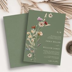 two wedding cards with flowers on them next to a pair of scissors and other items