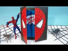 a spider - man birthday card is open to reveal the inside of it, with an action figure next to it