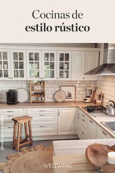 a kitchen with white cabinets and wooden stools