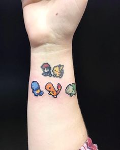 a person with a wrist tattoo that has four different video game characters on it