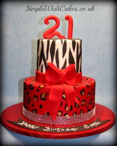 a red and black zebra print birthday cake with a number twenty on the top tier