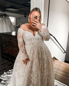 a woman taking a selfie in her wedding dress