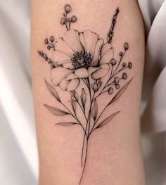 a black and white flower tattoo on the arm