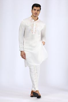 Ivory satin linen embroidered neckline kurta. Paired with narrow pant.
Component: 2
Pattern: Embroidery
Type Of Work: Bugle Beads
Neckline: Mandarin
Sleeve Type: Full
Fabric: Satin Linen
Color: Ivory
Other Details: 
Floral embroidery
Side slits
Occasion: Mehendi and Puja - Aza Fashions White Churidar With Floral Embroidery For Transitional Season, White Raw Silk Kurta For Formal Occasions, Formal White Raw Silk Kurta, White Kurta With Pearl Embroidery For Festivals, Festive White Linen Sets, Elegant White Churidar With Embroidered Border, White Silk Kurta With Embroidered Border, White Silk Sherwani For Diwali, Traditional White Linen Sets