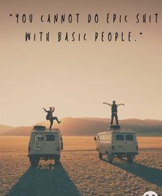 two people standing on top of an old vw van in the middle of nowhere