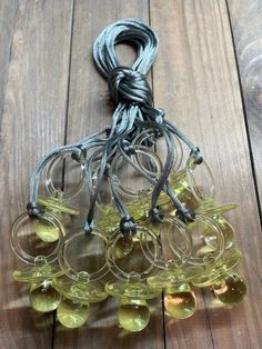 a bunch of wine glasses sitting on top of a wooden floor next to a string