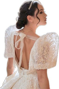 the back of a woman's wedding dress with an intricate lace design on it