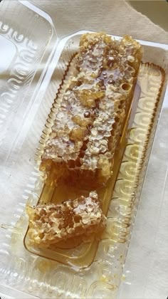 two pieces of cake sitting on top of a plastic tray next to a glass container