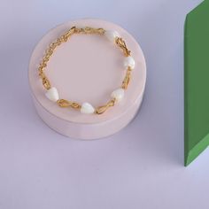 Description : This gold plated silver bracelet features delicately crafted Mother of Pearl tulips, symbolizing purity and devotion, gracefully arranged in perfect alternation with the eternal infinity symbol. Let the subtle elegance of this piece add a touch of grace to your casual ensemble. Product Information : Materials used : 925 Silver with 1.0-microns Gold Plating Length: 5.5 cm adjustable Contains: Comes in a piece Elegant Chain Bracelet With Extender As Gift, Elegant White Heart Bracelet For Formal Occasions, Elegant Metal Charm Bracelet With Delicate Chain, Minimalist Pearl Bracelet For Gift, Minimalist Metal Pearl Bracelet As Gift, Minimalist Metal Pearl Bracelet For Gift, Elegant Infinity Metal Bracelets, Elegant Charm Bracelet With Extender As Gift, Elegant Hypoallergenic Gold Metal Bracelet