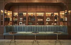 a living room filled with lots of furniture and bookshelves on top of wooden shelves