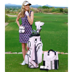 a woman is posing with her golf gear