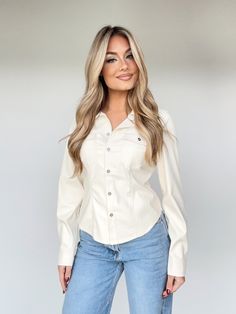 This Sleek Button Down Top is the perfect mix of style and comfort. Crafted from faux leather and featuring pocket details and button closures, this top is sure to make a statement. It is fitted and elevated, making for a trendy, yet versatile look. Its cropped length is chic and perfect for any brunch date, dinner, drinks, and shopping. Make it your go-to this winter. 100% Polyurethane Do not wash. Chic Fitted Tops With Buttoned Pockets, Trendy Workwear Blouse With Buttoned Pockets, Trendy Blouse With Buttoned Pockets For Work, Chic Everyday Tops With Buttoned Pockets, Trendy Workwear Blouse With Snap Buttons, Fitted Button-up Top With Buttoned Pockets, Fall Office Tops With Snap Buttons, Trendy Workwear Tops With Snap Buttons, Office Tops With Snap Buttons For Fall