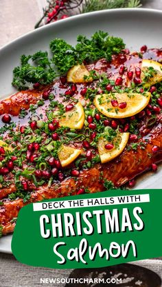 christmas salmon with pomegranate, lemons and herbs on a white plate