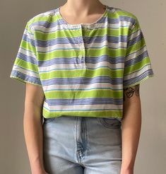 brand: Erika no tags but feels like cotton and fits like a small or medium (depending on how you want it to fit). has some very faint bleach stains on the sleeve (see last photo) PLEASE MESSAGE FOR MEASUREMENTS (model is 5'4" and 115 lbs with a 26" waist and 32" bust) Blue Vertical Striped T-shirt For Summer, Green Cotton Henley Neckline Top, Green Cotton Top With Henley Neckline, Casual Green Tops With Vertical Stripes, Casual Green Top With Vertical Stripes, 80's Clothes, 115 Lbs, 80s Outfit, Henley Shirt