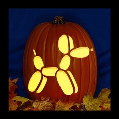 a carved pumpkin with an image of a dog on it's face and paw