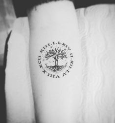 a small tree tattoo on the arm