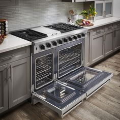 an oven with the door open and two burners on each side in a kitchen