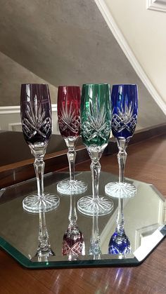 six wine glasses sitting on top of a glass tray