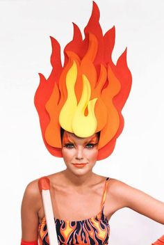 a woman with flames on her head holding a white stick