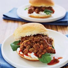 two white plates with sandwiches on them