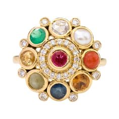 18 Karat Yellow Gold Nine Precious Gems "Navratan" Statement Ring This regal modern Navratan (nine) gem and diamond ring is exquisite. Navratnas of the nine gemstones represent the nine planets on which Indian astrology is based and wearing them together is believed to attract good positive vibes from all planets. The nine gems each have a symbolic meaning comprising of happiness, health, wisdom, energy, success, beauty, life, intellect, power, wealth, and marriage. The placing of each gemstone Nine Gems Ring, Exquisite Multi-stone Diamond Gemstones, Heirloom Multi-stone Yellow Gold Gemstones, Fusion Style Multi-stone Yellow Gold Gemstones, Yellow Gold Multi-stone Fusion Gemstones, Fusion Style Multi-stone Gemstones For Wedding, Fusion Multi-stone Gemstones For Weddings, Fusion Gemstones With Gemstone Accents, Fusion Style Wedding Gemstones With Multi-stone