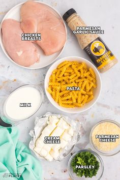 the ingredients to make chicken alfredo are shown in bowls on a marble countertop, including parmesan cheese, parmesan sauce, parmesan and parmesan