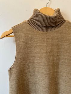 Made of soft touch fabric. Sleeveless and Tonal rib matching high collar. I have two colors: Dark Caramel and Grey. Brown High Neck Top For Layering, Fitted Beige Vest For Layering, Fitted High Neck Sweater Vest For Layering, Beige Ribbed Sleeveless Sweater Vest, Beige Ribbed Sweater Vest For Fall, Fitted Beige Ribbed Sweater Vest, Fitted Brown Funnel Neck Top, Ribbed Beige Tank Top For Fall, Beige Ribbed Tank Top For Fall