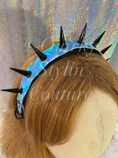 Beautiful and deadly - spiked headband. READY TO SHIP Features large spikes. Spikes are quality hard alloy with a polished finish. Black colour spikes. Adjustable and flexible wide headband. PVC - Vegan/PU leather material, Holographic blue-rainbow flash. Punk collar style base - with cool buckle and D rings on one side. Easy to wear. Soft velvet backing for comfort. Quality double glued for strength and finished with extra binding tape at the bottom. Handmade with love! :) POSTAGE: Postage basic price does not include Insurance, or sign on delivery. You can add these to your cart at checkout. I will take care to wrap items for post. They are FRAGILE - so I do recommend that you purchase postage insurance against damages. I will NOT refund or replace items broken in the post if you don't b Gothic Crown With Round Crown For Festival, Gothic Crown For Festivals With Round Crown, Gothic Round Crown For Festival, Adjustable Structured Crown For Festival, Adjustable Structured Crown For Festivals, Black Gothic Festival Headband, Adjustable Crown For Cosplay, Adjustable Crown Headband For Costume Party, Adjustable Headband Crown For Costume Party