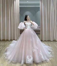 a woman in a white and pink wedding dress